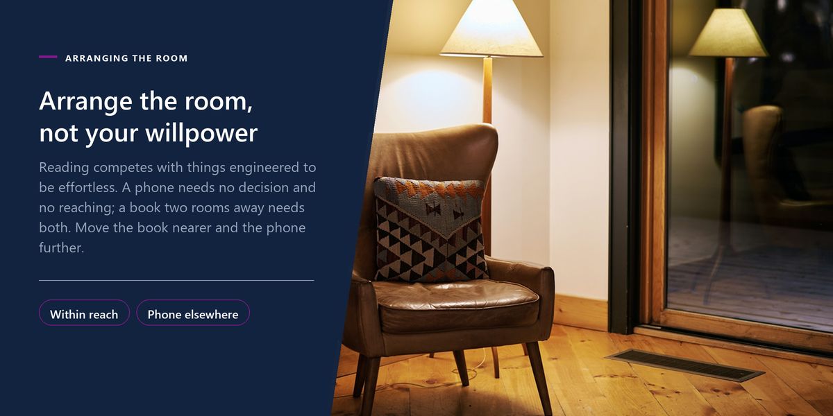 An empty armchair under a lit lamp in a dark room, next to a panel arguing that arrangement beats willpower.